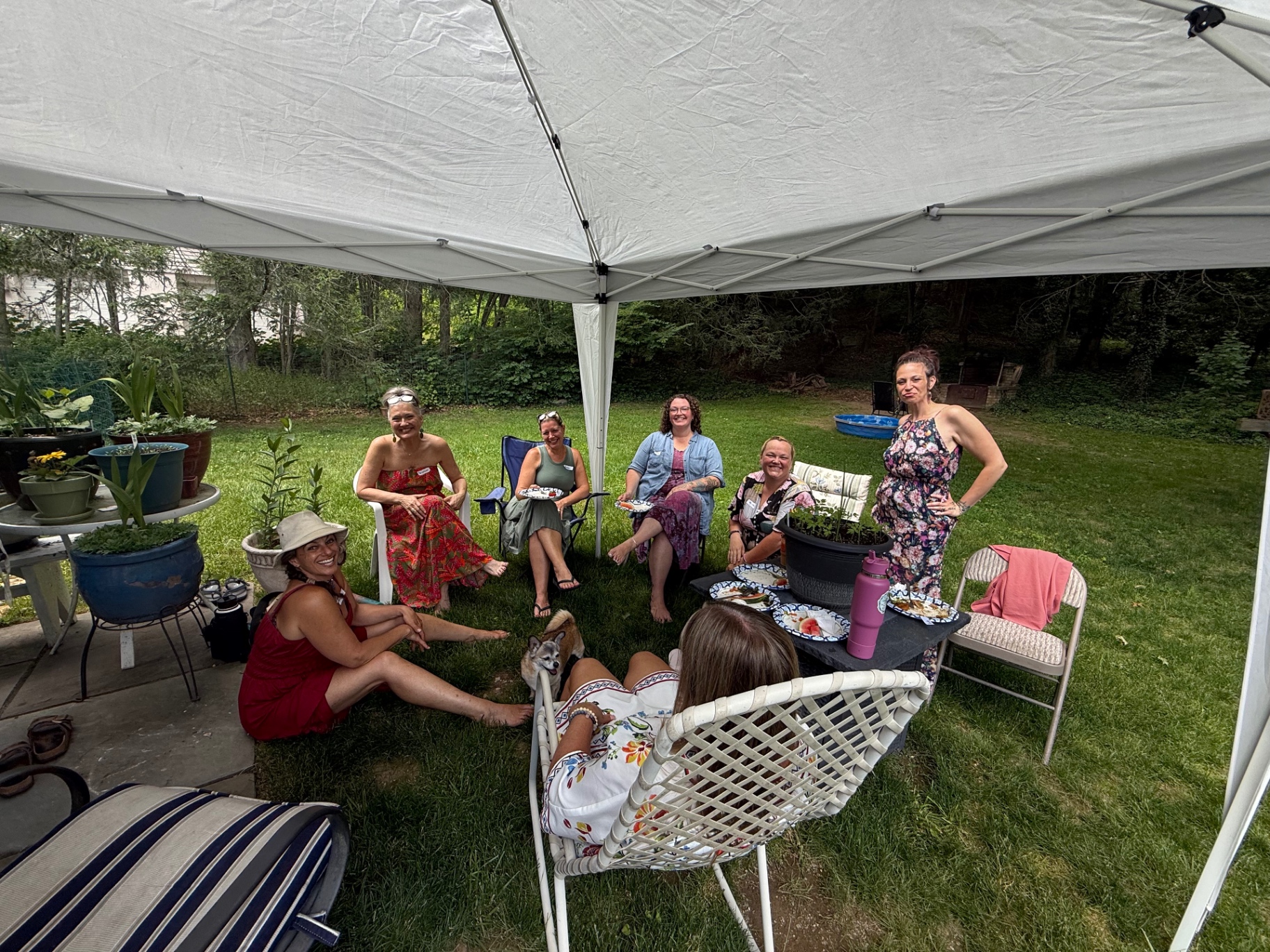Held Sacred sisters gathered under a tent in Kerrie's backyard